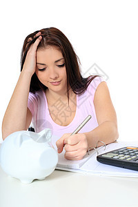 艰苦工作桌子会计青少年存钱罐女子金融黑发白色预算青年图片