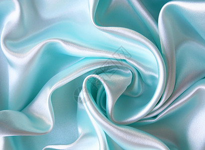 平滑优雅的蓝色丝绸作为背景曲线纺织品织物投标海浪布料折痕银色材料图片