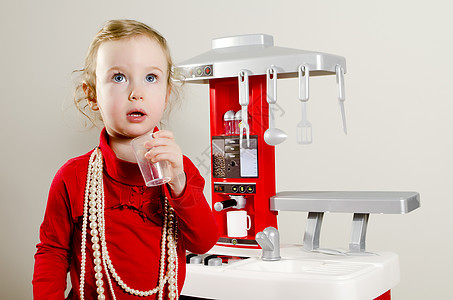 小可爱女孩在儿童厨房里玩耍红色婴儿童年游戏烹饪乐趣塑料喜悦角色幼儿园图片