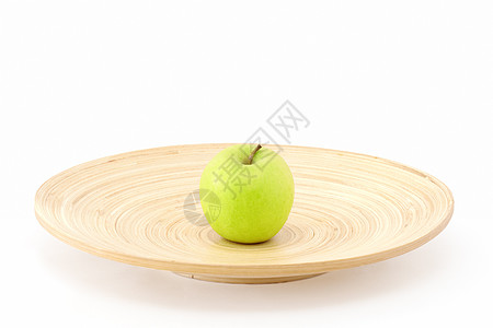 一个苹果在木板的中央盘子小吃早餐孤独白色甜点绿色水果黄色图片