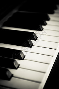 钢琴关在键盘上白色音乐宏观钥匙乐器艺术笔记黑色图片