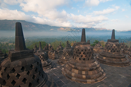 印度尼西亚中爪哇博罗布杜尔寺面孔旅行雕塑佛教徒建筑学日出艺术遗迹雕像佛塔图片