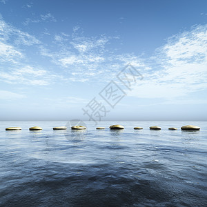 在蓝海中踩踏石头运动岩石卵石力量假期巨石旅行反射场景商业图片