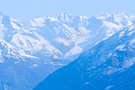 雪山山脉景观冰川顶峰环境阳光地标滑雪运动季节旅行远足图片