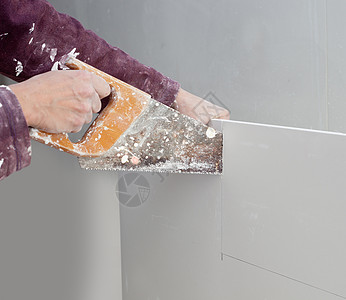 脏锯子 手贴的泥板墙板石膏板建筑石膏木板工具劳动刀具工作手工图片