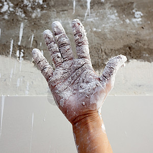 以石膏破碎的石膏手填料拼装工人维修建筑工艺家庭手指男人艺术背景图片