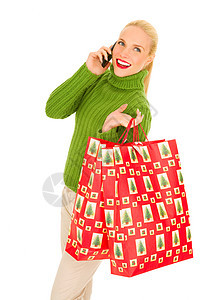携带流动和带圣诞礼物袋的妇女头发购物袋技术手机成人电话微笑工具购物年轻人图片