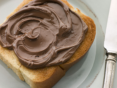 巧克力散漫的烤面包片切片鞋垫面包食物刀具黄油孩子们早餐用具烹饪小吃图片
