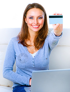 电商详情页使用信用卡和电脑在网上购物的笑女 Inte技术商业沙发笔记本命令闲暇信用女孩电子商务金融背景