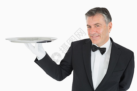 拿着银盘的服务员白色手套头发套装夹克衬衫衣冠服务奢华男性背景图片