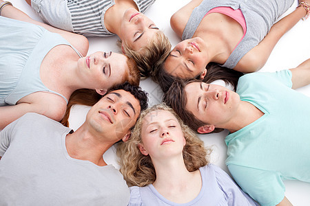 青少年与头一起睡在地板上大学乐趣学习圆圈男朋友桌子男性朋友们青年团队图片