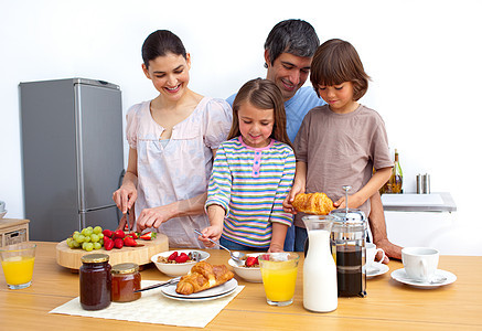 幸福的一家人一起吃早餐母亲厨房享受孩子们食物男性水果饮食朋友营养图片