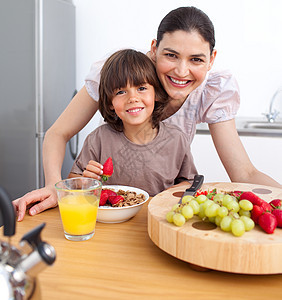 幸福的母亲和孩子在早餐中吃饭图片
