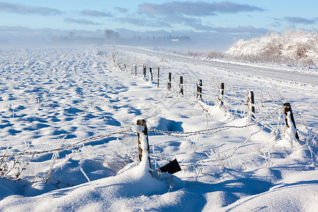 被刺穿的铁丝网围栏冬季景观图片