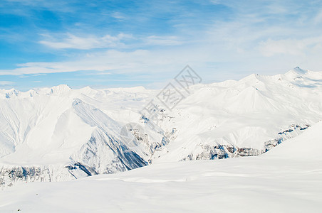 明亮的冬天天雪山旅行山脉冰川滑雪天空岩石阳光风景白色场景图片