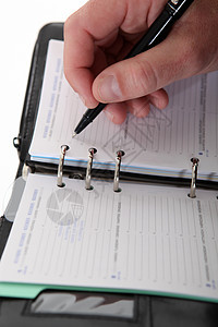 商业界人士在日记中写作日程经理女士规划师桌子文档教育协议日历记事本图片