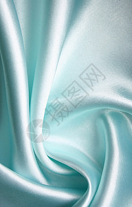 平滑优雅的蓝色丝绸作为背景纺织品织物布料白色材料银色折痕曲线投标图片