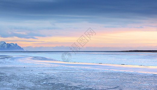 冰岛冷冻海岸假期日落环境海滩天空火山地平线蓝色海岸线海洋图片