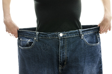 女人展示她瘦了多少体重重量损失饮食裤子腰部女孩女士蓝色女性减肥图片
