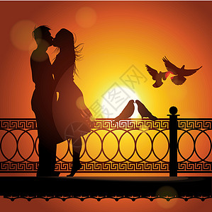 日落时亲吻一对情爱情侣的休眠图片