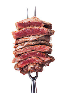 肉叉上的牛排切片食物牛肉美食家棕色白色金属用餐烧烤银器刀具图片