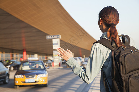 在机场搭乘出租车的年轻旅行者马尾辫前景收腰成年旅游飞机场机动性服装自由航班图片