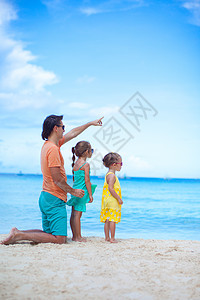 和两个女儿坐在热带沙滩度假时一起快乐的父亲 他有两个女儿乐趣男人海岸线孩子海滩家庭父母爸爸婴儿异国图片