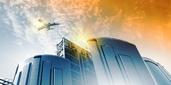 玻璃建筑天空中的平地喷射地标运输旅行公司金融玻璃高楼城市摩天大楼背景