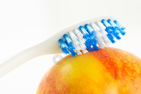 水果上的牙刷橙子医疗卫生饮食白色牙科健康饮食油桃生活方式食物图片
