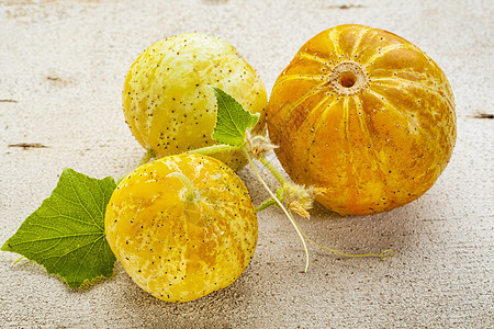 柠檬黄瓜黄色白色金子水果椭圆形圆形木头绿色球形叶子背景图片