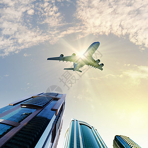 城市上空的飞机建筑物旅行翅膀办公室航空高楼天际金融航班街道图片