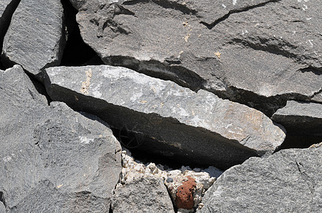 灰岩古城墙宏观石头大理石鹅卵石建筑学黑色石墙矿物风化纹理图片