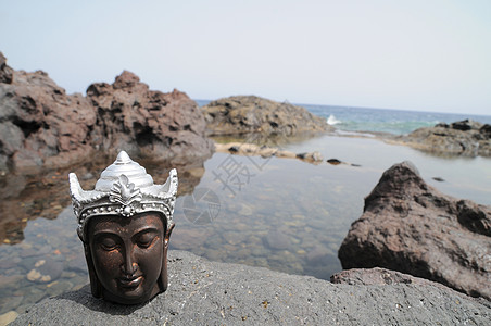 佛像雕像冥想男人太阳沉思塑像海岸旅行石头假期岩石图片