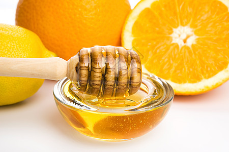 含柠檬和橙子水果的新鲜蜂蜜黄色玻璃健康饮食食物金子液体漏勺早餐美食家甜食图片
