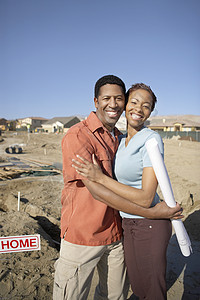 一对快乐的非裔美裔情侣在建筑工地拥抱的肖像图片