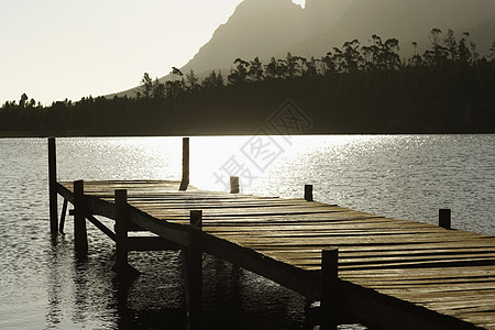 日落时在湖边木码头的太阳光图像图片