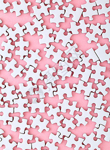 粉红背景上的白色谜题游戏闲暇团体粉色团队解决方案拼图玩具图片