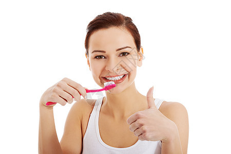 白顶的漂亮女人在刷牙牙齿牙膏刷子成人浴室情绪卫生牙医保健幸福图片