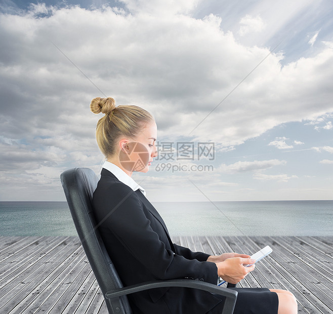 商业女商务人士坐在带平板板板的摇摆椅上套装商务触摸屏董事会人士地平线女性土地海岸线蓝色图片