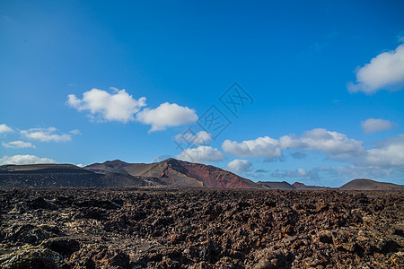 Timanfaya山脉火灾戏剧性海滩火山公园岩石石头太阳保护洞穴天空图片