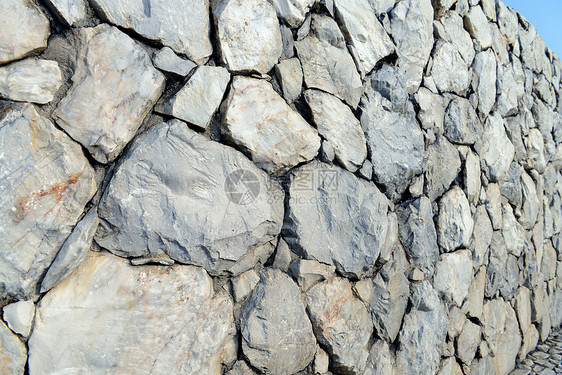 石墙背景和纹理水泥墙纸岩石构造历史建筑学圆圈房子城市材料图片