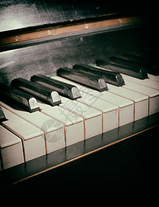 旧钢琴键盘古董棕褐色边缘划痕框架爵士乐艺术床单废料音乐图片