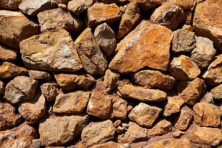 西班牙地中海古墙的经销物质素石头岩石壁垒材料小岛石方房子岛屿石墙石工图片
