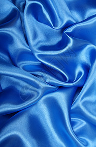 平滑优雅的蓝色丝绸作为背景天蓝色海浪织物曲线银色投标布料纺织品材料折痕图片