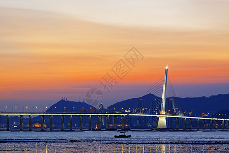 日出过长桥天际海洋码头天空晴天城市阳光旅游橙子地平线图片
