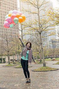 快乐笑笑的亚洲女人拿着气球快乐公园魅力女性女士乐趣微笑图片