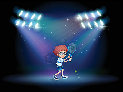 一个打网球的男孩 用聚光灯图片