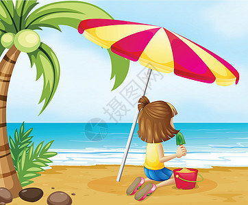 一个年轻女孩在海滩上 和城堡玩耍图片