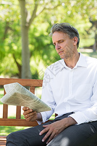 公园的商务人士阅读报纸空闲长椅衬衫人士时间绿地商务闲暇商业成人图片