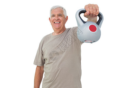 一位高年长者的肖像 他用茶壶的铃声进行锻炼退休活动双手肌肉老年训练运动员运动服起重成人图片